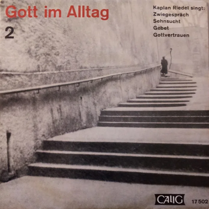 Black-and-white record cover for ‘God in Everyday Life 2’, featuring a photograph of a flight of steps against a wall with the figure of a monk in the background; ‘Chaplain Riedel sings: Dialogue, Longing, Prayer, Trust in God’; published by Calig