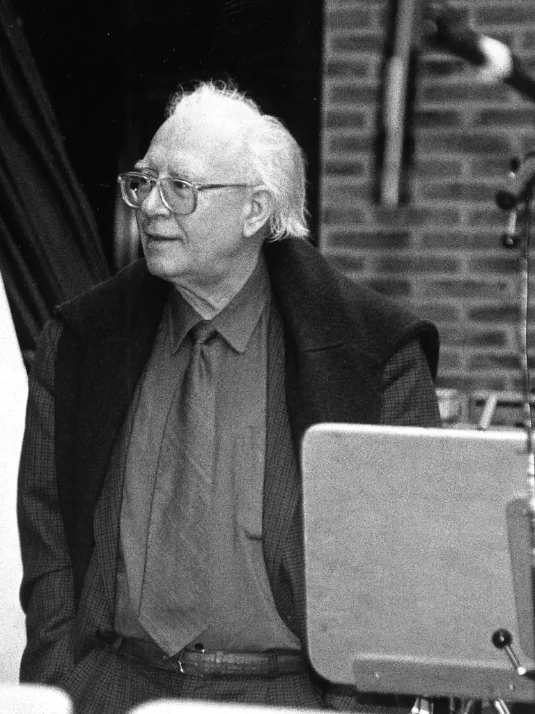 Portrait photograph: Bertold Hummel wearing glasses during a photo shoot.