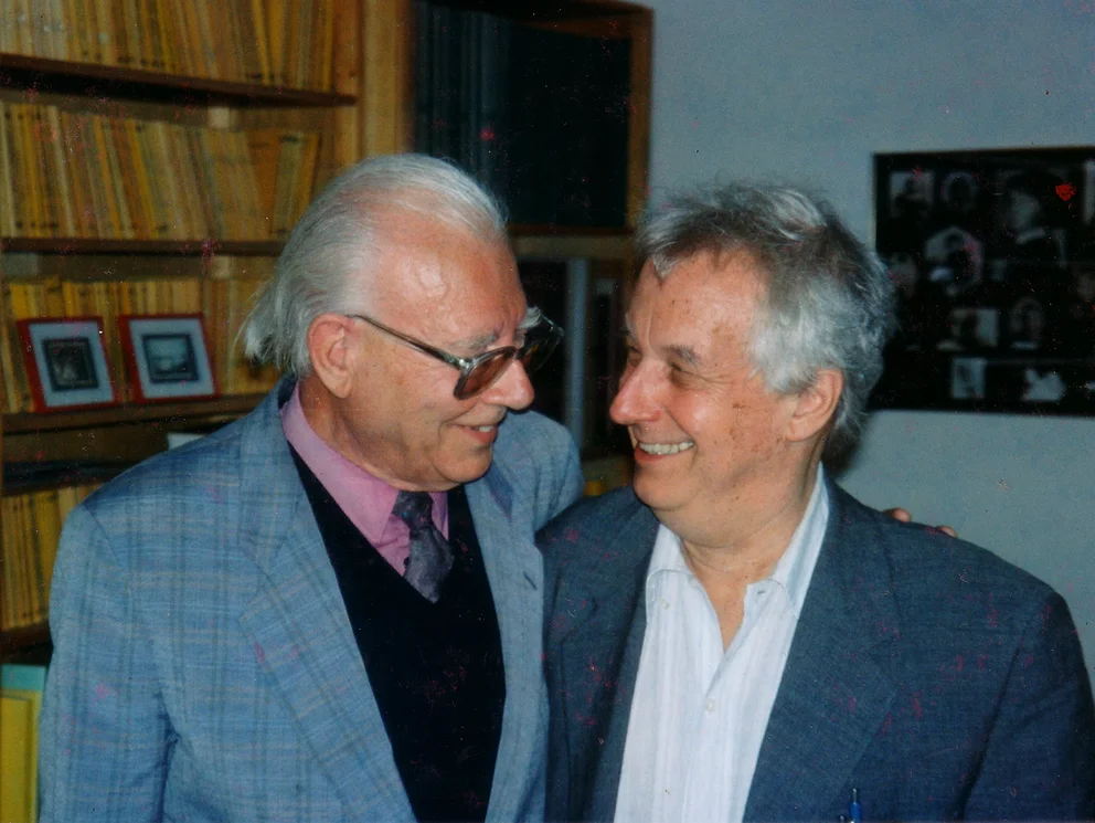 Colour photograph: the composers Bertold Hummel and Dieter Schnebel smiling side by side at Schott Publishers, Mainz, early 1998
